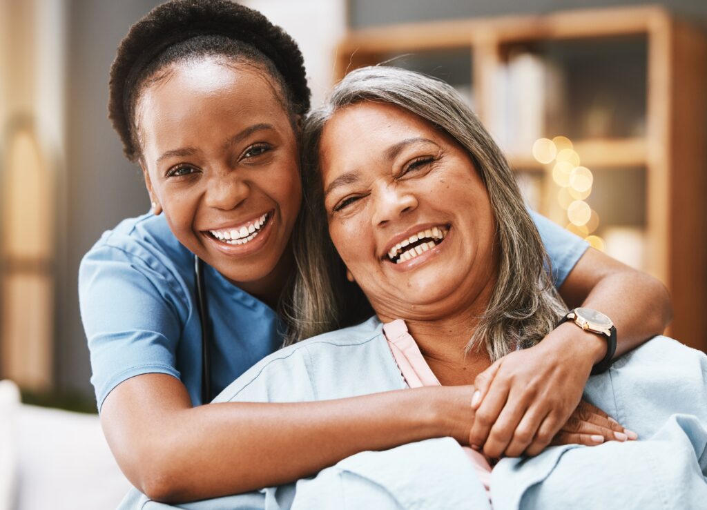 Senior,Care,,Hug,And,Portrait,Of,Nurse,With,Patient,For Two smiling women in the PA training program